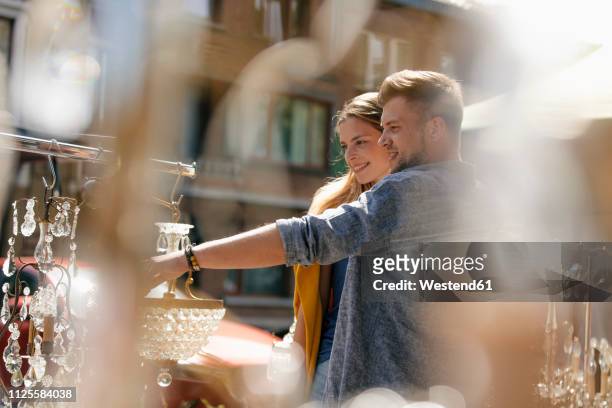 belgium, tongeren, happy young couple on an antique flea market - antique shop stockfoto's en -beelden