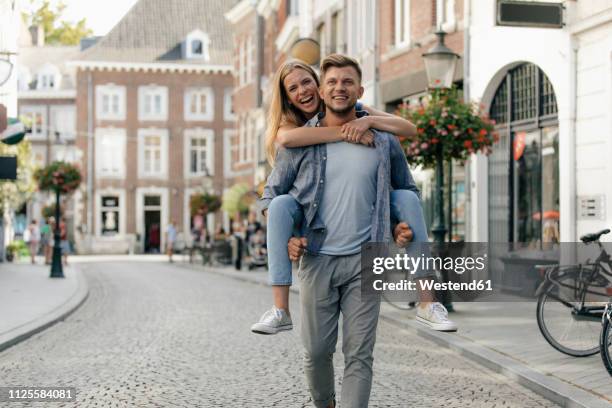 netherlands, maastricht, happy young couple in the city - young couple exploring city stock pictures, royalty-free photos & images