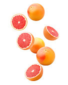 Falling grapefruits isolated on white background, clipping path, full depth of field