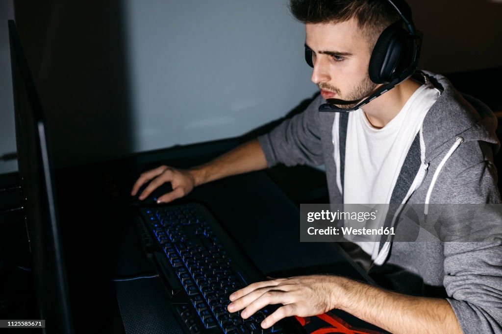 Young Man Sitting At His Pc Playing Computer Games High-Res Stock Photo ...
