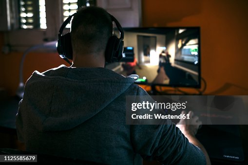 Young Man Sitting At His Pc Playing Computer Games High-Res Stock Photo ...