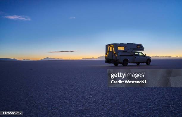 bolivia, salar de uyuni, camper on salt lake at sunset - christmas lights isolated stock-fotos und bilder