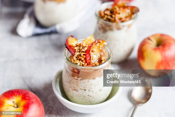 apple pie overnight oats with caramelized apples and hazelnuts - porridge stock pictures, royalty-free photos & images