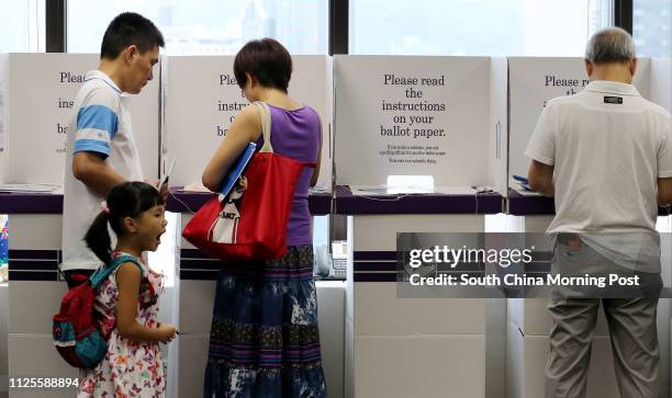 Voters fill ballots at the voting centre of the Australian Consulate-General in Wan Chai. 07SEP13