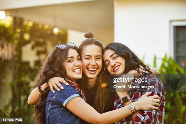 portrait of women embracing during garden party - celebration fl stock pictures, royalty-free photos & images