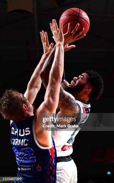 Kennedy of Melbourne United shoots guarded by Anthony Drmic of the Adelaide 36ers during the round 15 NBL match between the Adelaide 36ers and...