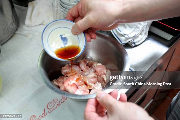 Imai Masakazu, Head Chef of Japanese restaurant Inakaya, demonstrates how to prepare oyakodon, a classic Japanese dish of simmered chicken and egg on...