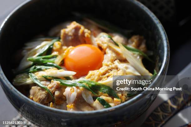 Imai Masakazu, Head Chef of Japanese restaurant Inakaya, demonstrates how to prepare oyakodon, a classic Japanese dish of simmered chicken and egg on...