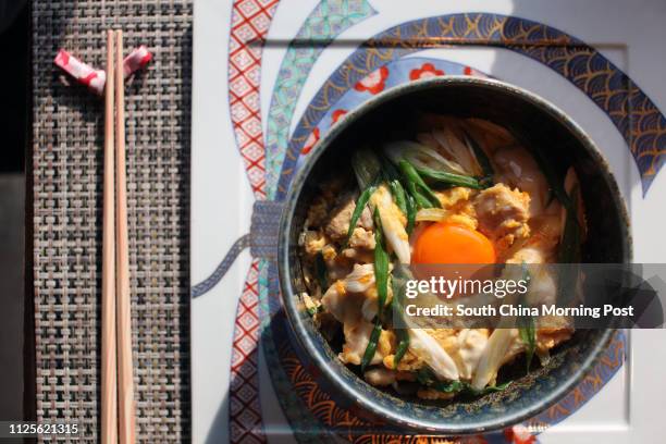 Imai Masakazu, Head Chef of Japanese restaurant Inakaya, demonstrates how to prepare oyakodon, a classic Japanese dish of simmered chicken and egg on...