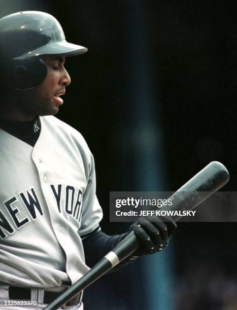 New York Yankees Bernie Williams looks at his bat after striking out to end their half of the 1st inning against the Detroit Tigers 18 April 1999 in...