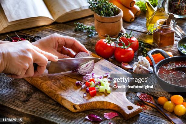 cutting fresh vegetables on rustic wooden kitchen table - cooking cookbook stock pictures, royalty-free photos & images