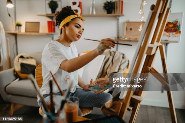 girl painting on canvas - creative occupation stock pictures, royalty-free photos & images