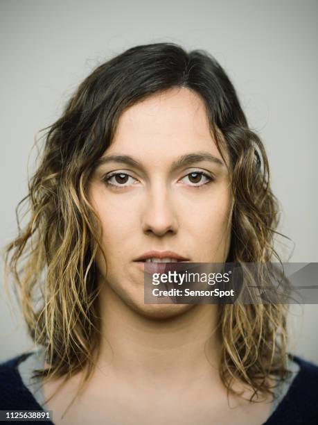 real caucasian young woman with blank expression looking at camera - mug shot stock pictures, royalty-free photos & images