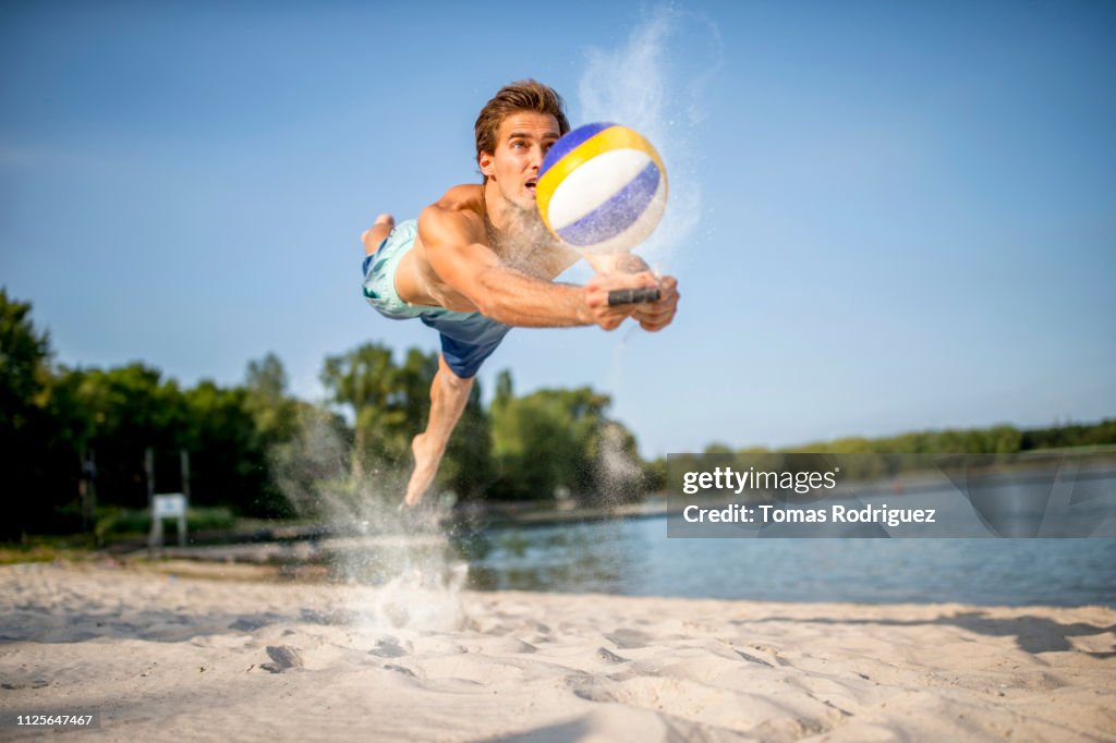 Beach volleyball player digging the ball
