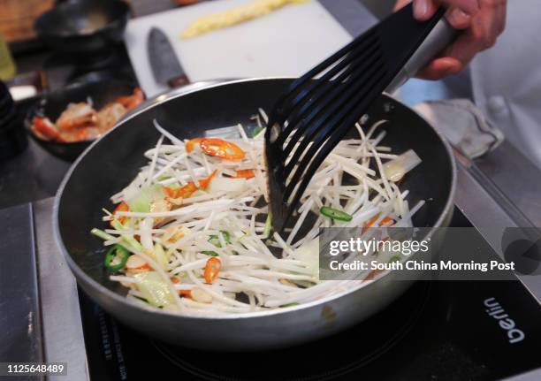 Jesse Teh, head chef of Secret Ingredients, demonstrates how to make prawn char kway teow. 19NOV13