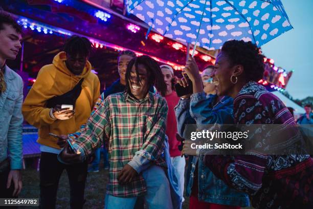 dancing at a funfair - music festival phone stock pictures, royalty-free photos & images