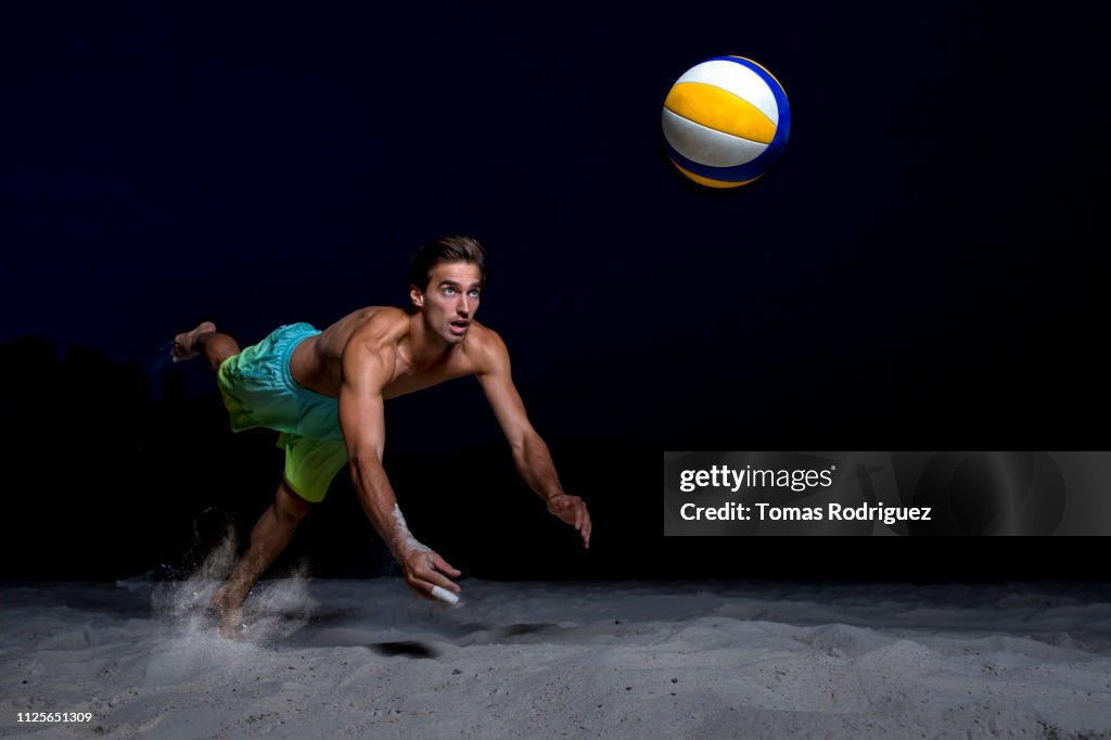 Beach volleyball player digging the ball