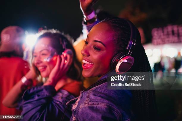 friends dancing in a silent disco - clubbing stock pictures, royalty-free photos & images