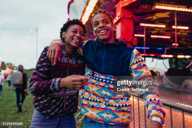 young couple at a funfair - fair game stock pictures, royalty-free photos & images