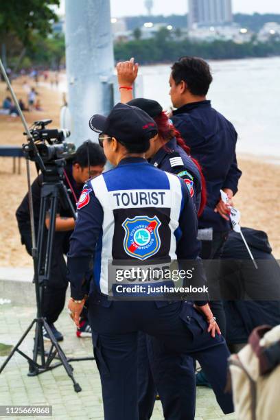 thai tourist policeman a nd photographers - pattaya stock pictures, royalty-free photos & images