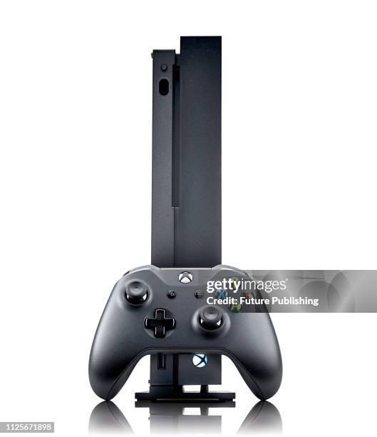 Microsoft Xbox One home video games console and Xbox One wireless controller, taken on August 16, 2017.