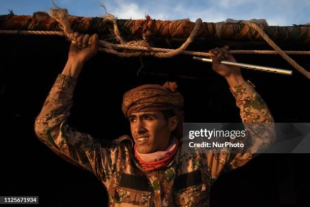 Mohammed, a member of Al B'doul, a local Bedouin tribe, watches a sunset outside his tent-home, at the top of the mountain located near Ad Deir ,...