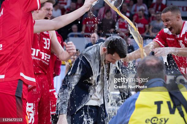 Bamberg's head coach Federico Perego getting a beer shower from his players. In the Final of the Basketball Bundesliga Pokal Brose Bamberg plays...