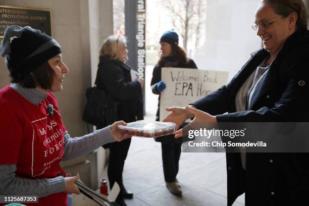 Moms Clean Air Force activist Liz Brandt welcomes Environmental Protection Agency employees back to work with cinnamon rolls outside the Federal...