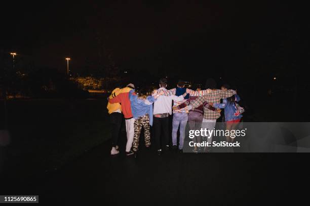 children of the night - group arm in arm stock pictures, royalty-free photos & images