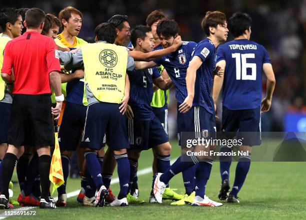 Yuya Osako of Japan celebrates with team mates after he scores his and his sides second goal during the AFC Asian Cup semi final match between Iran...