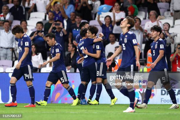 Takumi Minamino of Japan celebrates with team mates scores his sides third goal during the AFC Asian Cup semi final match between Iran and Japan at...