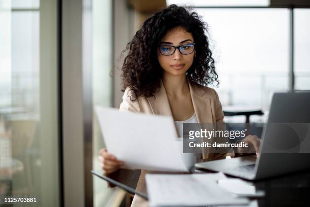 young businesswoman preparing for business meeting - document stock pictures, royalty-free photos & images
