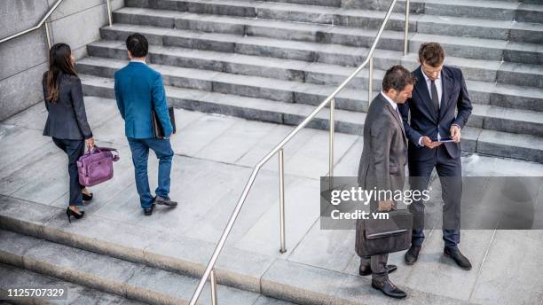 two  businessmen talking on stairs - laptop bag stock pictures, royalty-free photos & images