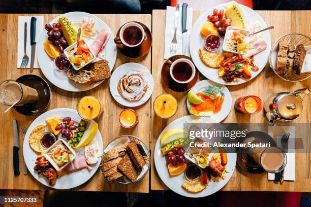 directly above view of brunch food on the table in a restaurant - breakfast buffet stock pictures, royalty-free photos & images