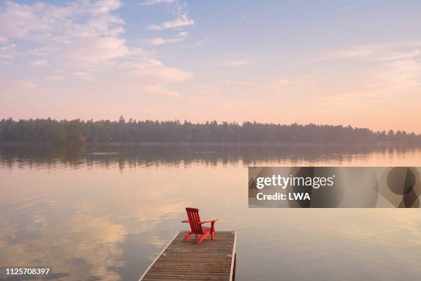 adirondack chair on dock at sunrise - slow living stock pictures, royalty-free photos & images