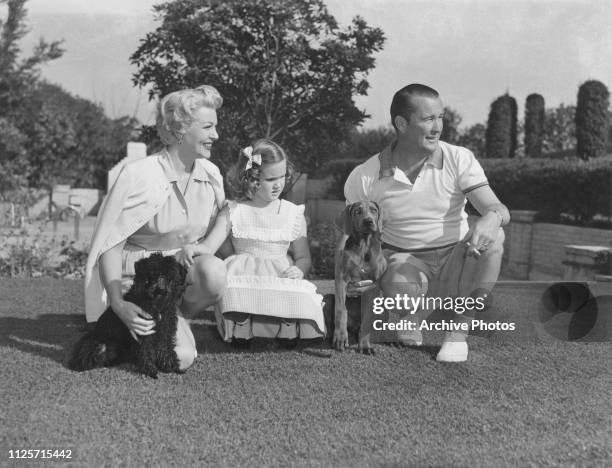American actress Lana Turner with her third husband, Bob Topping , Cheryl Crane, her daughter by second husband, Steve Crane, and two pet dogs at...