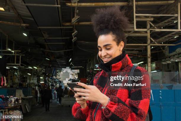 trans woman in front of a street market - israeli-woman stock pictures, royalty-free photos & images