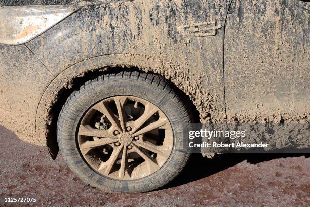 Car covered with mud and dirt parked in Santa Fe, New Mexico.