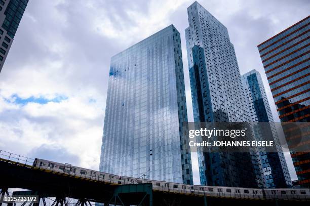 Subway is seen in front of skyscrapers in Long Island City on February 18, 2019 in the Queens borough of New York City. - Seattle-based online...