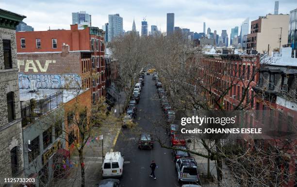 Man walks in a street in Long Island City on February 18, 2019 in the Queens borough of New York City. - Seattle-based online retailer Amazon said...