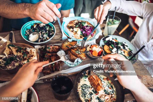 enjoying lunch with friends - friendship hands stock pictures, royalty-free photos & images