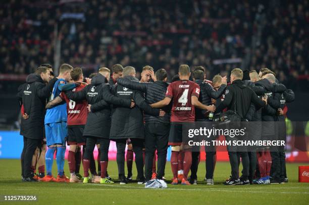 Nuernberg's team stand together on the pitch after the German first division Bundesliga match between 1 FC Nuremberg and Borussia Dortmund in...