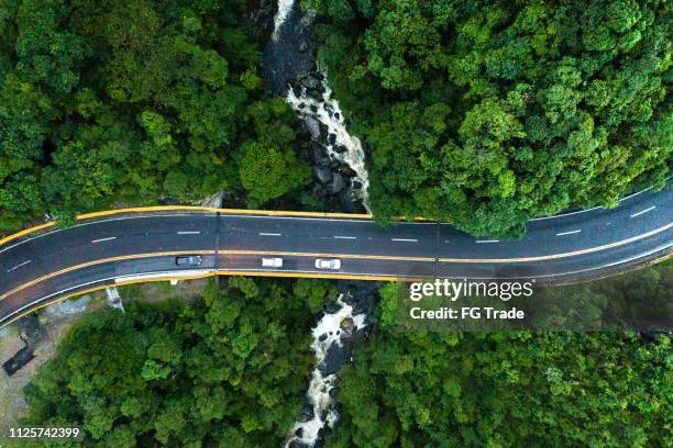 aerial view of road in a forest - driving mountain road stock pictures, royalty-free photos & images