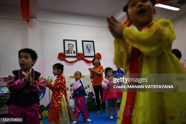 Vietnamese children perform in front of the portraits of the late North Korean leader, Kim Il Sung and Vietnam's Ho Chi Minh at the Vietnam-North...