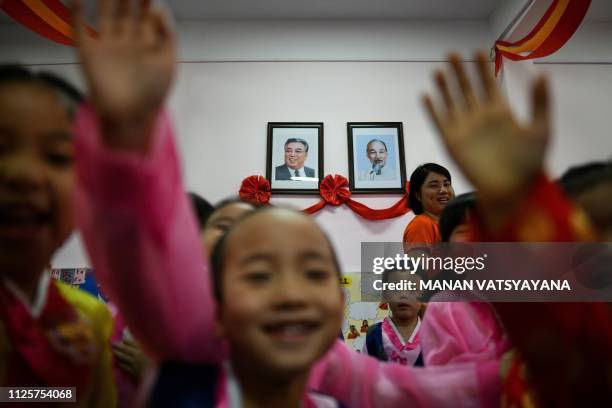 Vietnamese children play in front of the portraits of the late leaders of North Korea, Kim Il Sung and Vietnam's, Ho Chi Minh at the Vietnam-North...