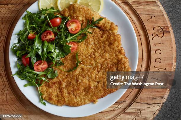 Costoletta alla Milanese - Pan-fried Veal Chop, Arugula and Plum Tomatoes photographed I Ricchi in Washington, DC on February 1, 2019. .