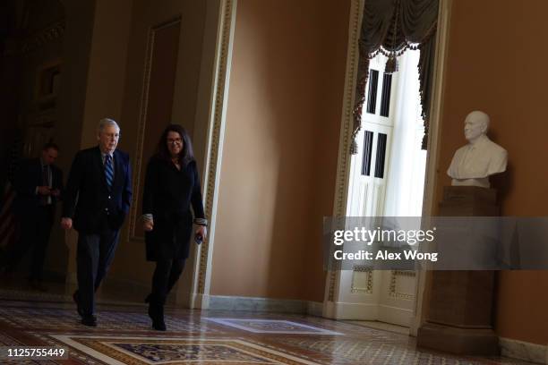 Senate Majority Leader Sen. Mitch McConnell walks towards the Senate chamber with Secretary for the Majority Laura Dove January 28, 2019 at the U.S....