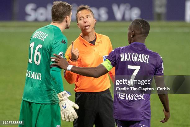 January 27: Referee Johan Hamel discussing a decision with goalkeeper Ludovic Butelle of Angers as Max Gradel of Toulouse observes during the...