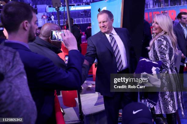 Head coach Bill Belichick of the New England Patriots and girlfriend Linda Holliday talk with the media during Super Bowl LIII Opening Night at State...