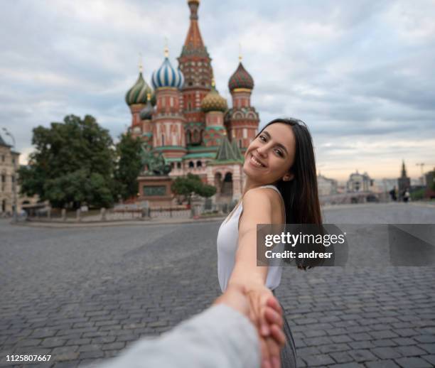 happy woman leading the way while traveling in london - st basil's cathedral stock pictures, royalty-free photos & images